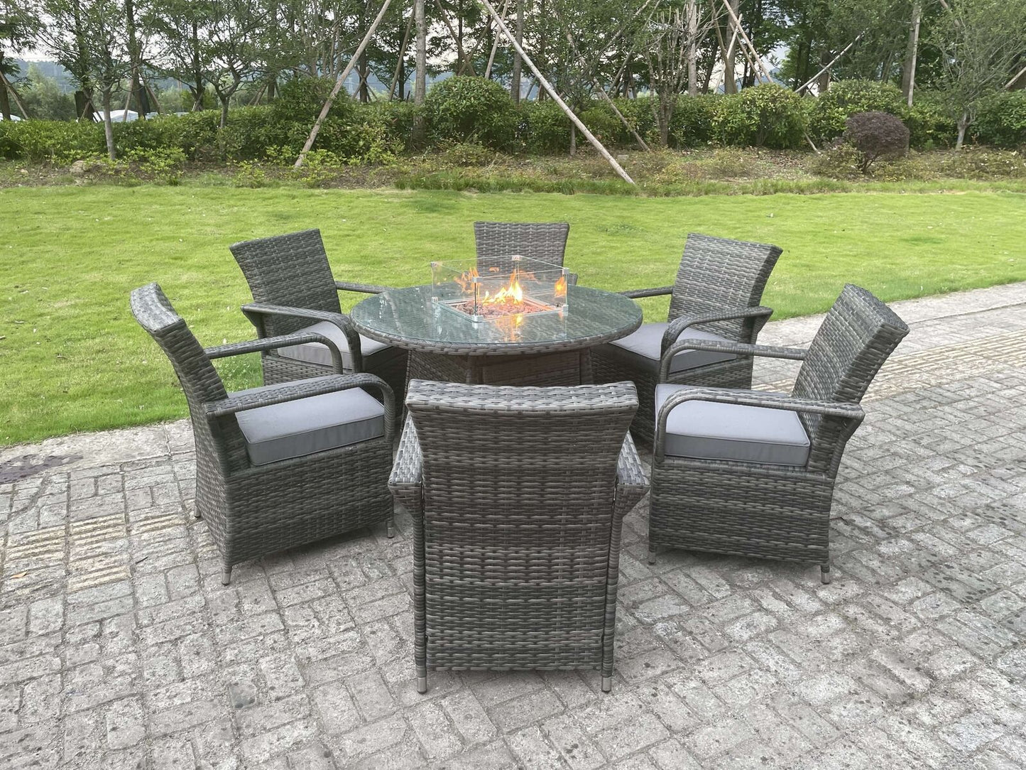 Dark grey rattan dining chairs with thick cushions and ergonomic high-back design
