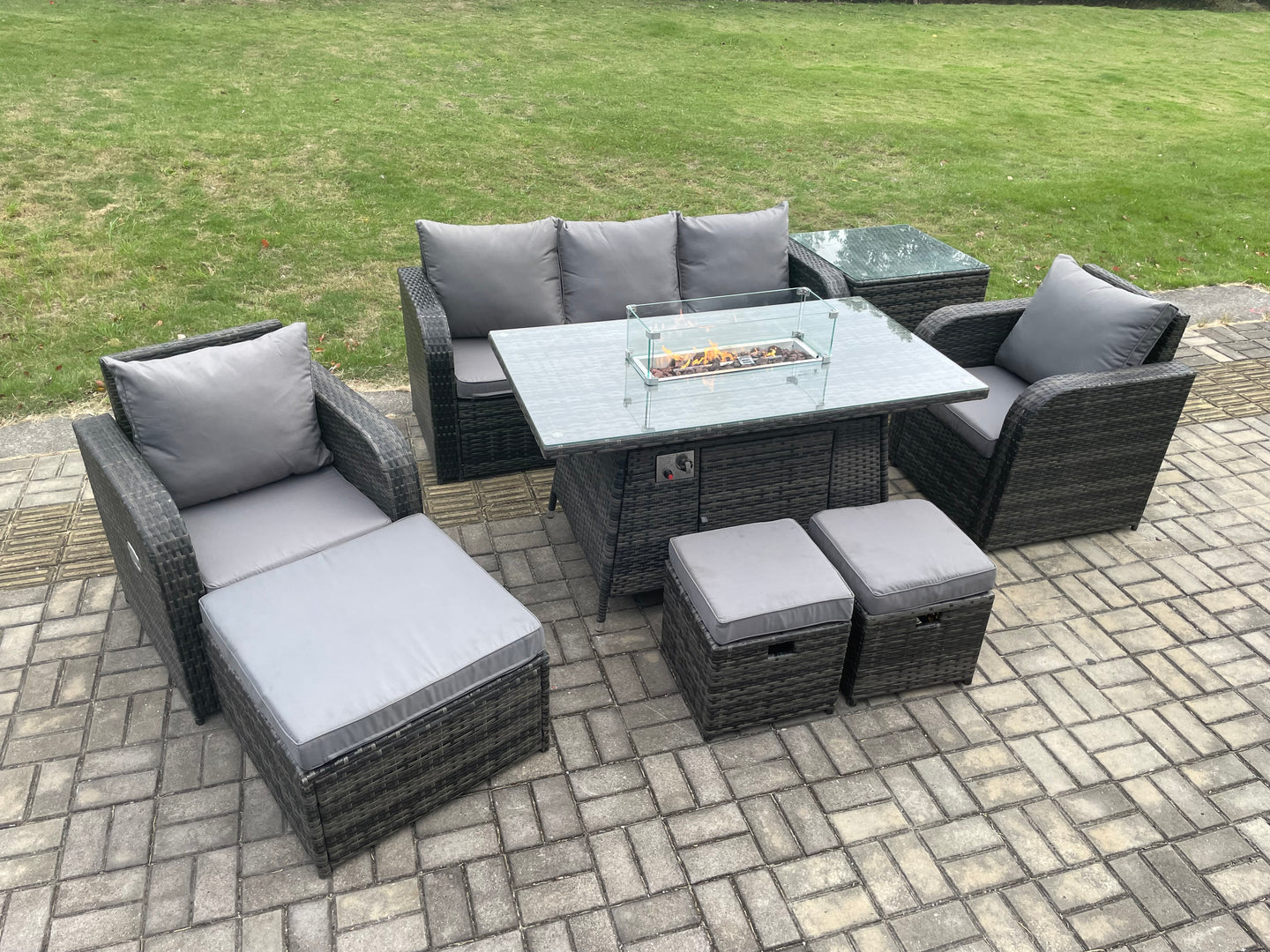 Dark grey wicker rattan garden set with gas fire pit table, 3-seater sofa, and reclining chairs.