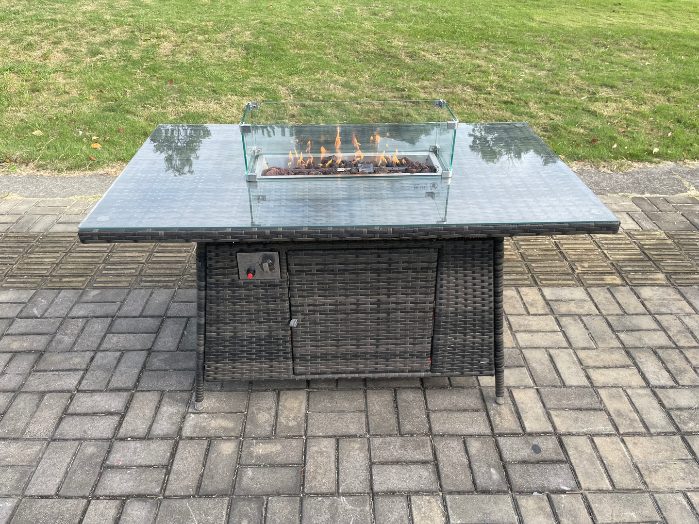 Dark grey wicker rattan garden set with gas fire pit table, 3-seater sofa, and reclining chairs.